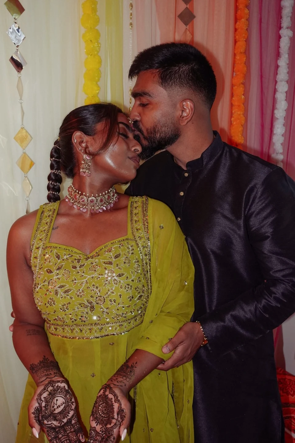 A groom kissing his partner on the forehead