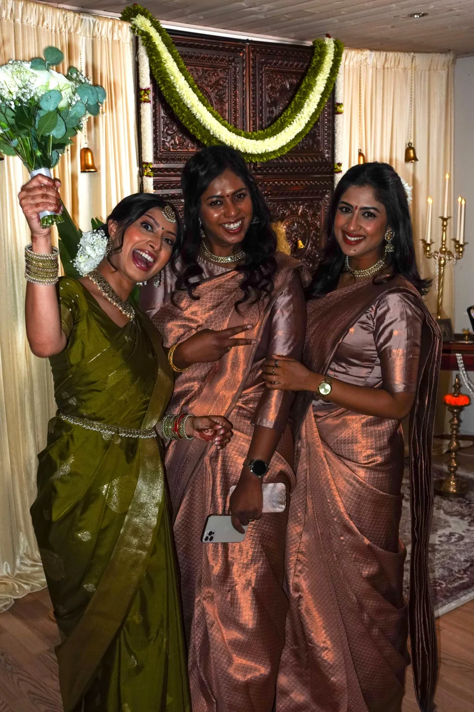 Three guests laughing together at a wedding